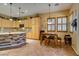 Bright kitchen with light wood cabinets, tile flooring, a stone-accented island, and a breakfast nook at 3801 W Hammer Ln, North Las Vegas, NV 89031