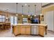 Kitchen featuring wooden cabinets, granite countertops, stainless steel appliances, and open to the living area at 3801 W Hammer Ln, North Las Vegas, NV 89031