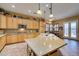 Bright kitchen with wooden cabinets, granite countertops, a breakfast bar, and access to the patio at 3801 W Hammer Ln, North Las Vegas, NV 89031
