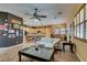Open concept living room featuring tile floors, a ceiling fan, and stone accents around the kitchen island at 3801 W Hammer Ln, North Las Vegas, NV 89031
