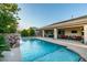 Inviting pool with a rock waterfall feature and covered patio, perfect for outdoor enjoyment at 3801 W Hammer Ln, North Las Vegas, NV 89031