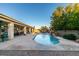 Relaxing backyard featuring a pool with a waterfall, a covered patio, and mature landscaping at 3801 W Hammer Ln, North Las Vegas, NV 89031