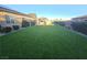 Expansive backyard featuring lush artificial turf, perfect for outdoor activities and low maintenance at 4242 Helena Hideaway Ct, Las Vegas, NV 89129