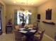 Cozy dining space with natural light, an elegant centerpiece, and a comfortable setting for meals at 4242 Helena Hideaway Ct, Las Vegas, NV 89129
