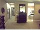 Hallway area with a decorative mirror, dresser, and access to various rooms at 4242 Helena Hideaway Ct, Las Vegas, NV 89129