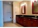 Bathroom featuring double sinks, black countertops and custom wood cabinets at 4575 Dean Martin Dr # 3007, Las Vegas, NV 89103