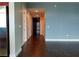 Hallway leading to the front door with hardwood floors and gray accent wall at 4575 Dean Martin Dr # 3007, Las Vegas, NV 89103