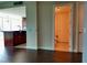Open living space with hardwood floors, view into the kitchen, and access to a full bathroom at 4575 Dean Martin Dr # 3007, Las Vegas, NV 89103