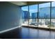 Living room with hardwood floors, grey accent wall, and expansive city views at 4575 Dean Martin Dr # 3007, Las Vegas, NV 89103