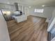 An open floor plan features a kitchen island with a cooktop and hardwood style flooring at 4754 Marnell Dr, Las Vegas, NV 89121