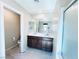 Modern bathroom with double sinks, tile flooring, and a mirrored wall at 483 Fairview Hills St, Las Vegas, NV 89138