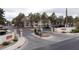 View of the gated community entrance with well manicured landscaping and signage at Las Casitas at 4866 Nara Vista Way # 202, Las Vegas, NV 89103