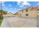 Spacious backyard area featuring a concrete patio, privacy wall, and manicured landscaping at 5516 Cory Pl, Las Vegas, NV 89107