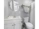 Cozy bathroom featuring a corner sink and vanity adjacent to the toilet and shower with curtain rod at 5516 Cory Pl, Las Vegas, NV 89107