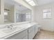 Bright bathroom features dual sinks with white marble countertops and a large mirror at 5516 Cory Pl, Las Vegas, NV 89107