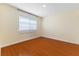 Bedroom featuring hardwood flooring, a window with blinds, and neutral walls at 5516 Cory Pl, Las Vegas, NV 89107