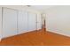 Bedroom featuring hardwood flooring, white sliding closet, and neutral walls at 5516 Cory Pl, Las Vegas, NV 89107