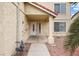 View of the home's front entrance, featuring a white door, side window and desert landscaping at 5516 Cory Pl, Las Vegas, NV 89107