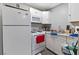 Compact kitchen featuring white appliances, ample counter space, and overhead cabinetry at 5516 Cory Pl, Las Vegas, NV 89107