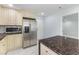 Spacious kitchen featuring stainless steel appliances, custom cabinets, and an island, perfect for meal preparation at 5516 Cory Pl, Las Vegas, NV 89107