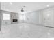 Expansive living room featuring marble floors, a fireplace, and multiple windows for abundant natural light at 5516 Cory Pl, Las Vegas, NV 89107