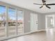 Bright living room with large windows and a ceiling fan at 612 Burton St, Henderson, NV 89015