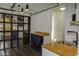 Garage transformed into a living space with a kitchenette, black-framed glass door, and industrial style lights at 6244 Eugene Ave, Las Vegas, NV 89108