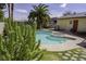 Backyard in-ground pool with attached hot tub and mature desert landscaping at 6244 Eugene Ave, Las Vegas, NV 89108