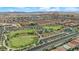 The aerial view captures a community with a large park, open spaces, and neatly arranged residential areas at 6435 Parrot Ridge Ct, Las Vegas, NV 89139
