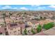 This aerial view showcases a community with homes, many featuring solar panels, and lush landscaping at 6435 Parrot Ridge Ct, Las Vegas, NV 89139