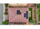 An aerial view showcases the home's tile roof, solar panels, brick patio and lush backyard at 6435 Parrot Ridge Ct, Las Vegas, NV 89139