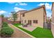 The home's backyard has artificial turf, a paver patio with outdoor furniture, and low-maintenance landscaping at 6435 Parrot Ridge Ct, Las Vegas, NV 89139