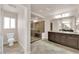 Bathroom featuring a glass-enclosed shower, tile floors, and a dark wood vanity at 6435 Parrot Ridge Ct, Las Vegas, NV 89139