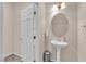 Stylish powder room with a pedestal sink and modern fixtures at 6435 Parrot Ridge Ct, Las Vegas, NV 89139