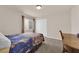 A well lit bedroom with carpet, a desk and chair, and window at 6435 Parrot Ridge Ct, Las Vegas, NV 89139