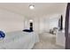 A spacious bedroom features carpet, a chair, and ample natural light at 6435 Parrot Ridge Ct, Las Vegas, NV 89139