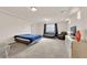 Spacious bedroom with plush carpet, recessed lighting, and a comfortable seating area at 6435 Parrot Ridge Ct, Las Vegas, NV 89139