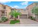 Inviting two-story home with a landscaped front yard, brick driveway, and a two-car garage at 6435 Parrot Ridge Ct, Las Vegas, NV 89139