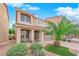 Inviting two-story home with desert landscaping, a charming front porch, and a spacious two-car garage at 6435 Parrot Ridge Ct, Las Vegas, NV 89139