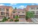 An elevated view of a two-story home with a landscaped front yard and brick driveway at 6435 Parrot Ridge Ct, Las Vegas, NV 89139