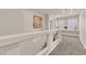 Bright hallway featuring neutral tones, a large Buddha art piece, and staircase access at 6435 Parrot Ridge Ct, Las Vegas, NV 89139