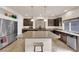 Spacious kitchen featuring dark wood cabinets, stainless steel appliances, and a center island at 6435 Parrot Ridge Ct, Las Vegas, NV 89139