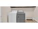 A well lit laundry room features a white washing machine and gray dryer, offering convenience and functionality at 6435 Parrot Ridge Ct, Las Vegas, NV 89139