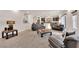 Open-concept living area with comfortable seating and an adjacent kitchen at 6435 Parrot Ridge Ct, Las Vegas, NV 89139
