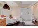 Well-lit bathroom featuring a glass-enclosed shower, a bathtub with a tiled step, and a toilet at 6491 Bright Nimbus Ave, Las Vegas, NV 89139