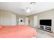 Comfortable bedroom with a ceiling fan, TV, dresser, and soft carpet at 6491 Bright Nimbus Ave, Las Vegas, NV 89139
