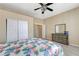 Bedroom with wood-look floors, closet with sliding doors, and a neutral color scheme at 6491 Bright Nimbus Ave, Las Vegas, NV 89139