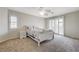 Relaxing bedroom with a ceiling fan, plantation shutters, and soft carpeting at 6491 Bright Nimbus Ave, Las Vegas, NV 89139