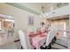 Elegant dining room adjacent to the foyer with a beautifully set table and modern chandelier at 6491 Bright Nimbus Ave, Las Vegas, NV 89139