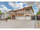 Beautiful two-story home with three-car garage, a charming front garden and decorative gate at 6491 Bright Nimbus Ave, Las Vegas, NV 89139